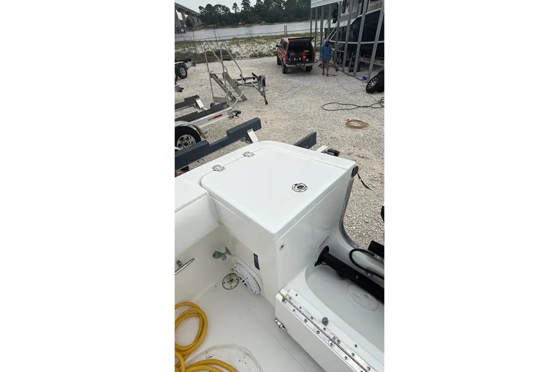 Slide: The Image of 2007 SeaCraft SC 32 Master Angler boat interior with storage compartment and coiled yellow hose. - 36