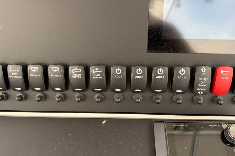 Slide: The Image of Control panel of a 2007 SeaCraft SC 32 Master Angler boat with various switches. - 17