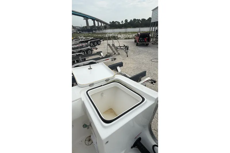 Slide: The Image of 2007 SeaCraft SC 32 Master Angler boat with open storage compartment, parked near trailers. - 34