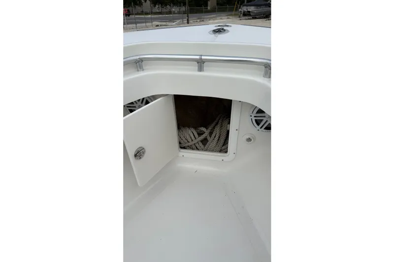 Slide: The Image of 2007 SeaCraft SC 32 Master Angler boat with open storage compartment and coiled rope. - 22