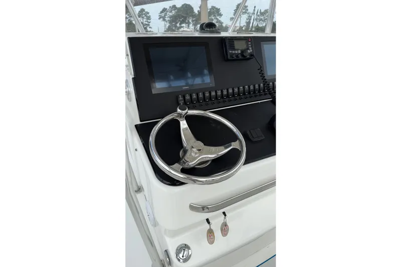 Slide: The Image of Steering console of 2007 SeaCraft SC 32 Master Angler with modern controls and displays. - 13
