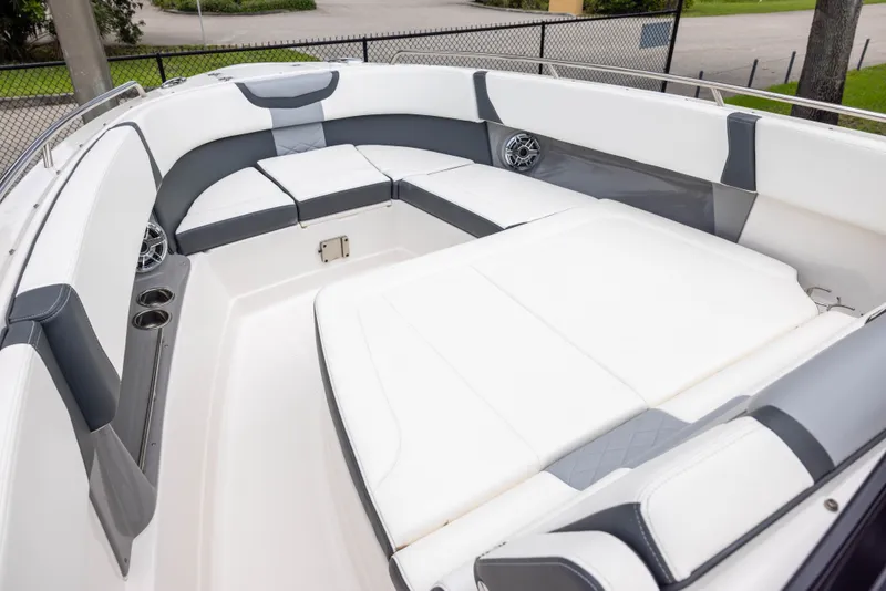 Slide: The Image of 2023 Chaparral 300 OSX: Spacious, sleek seating area with gray and white upholstery. - 11
