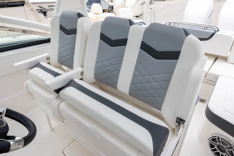 Slide: The Image of Three luxurious, padded seats in white and gray on a modern boat. - 10