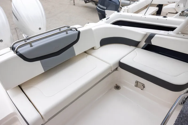 Slide: The Image of The image shows the cockpit of a 2023 Chaparral 300 OSX with white and gray upholstery. - 8