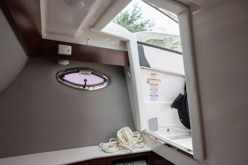Slide: The Image of Interior of the 2023 Chaparral 300 OSX with a porthole and rope. - 16