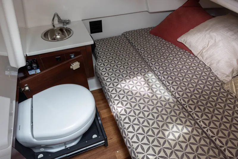 Slide: The Image of Interior of the 2023 Chaparral 300 OSX with a bed, sink, and toilet. - 15
