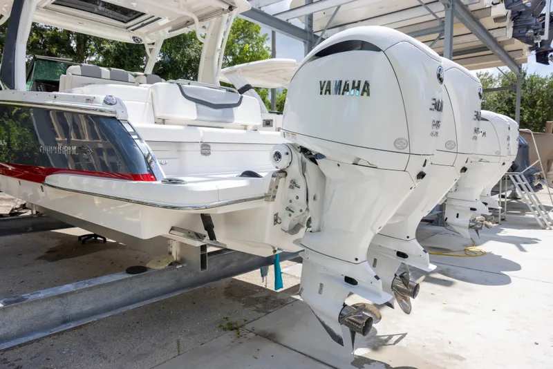 Slide: The Image of The image shows a 2023 Chaparral 300 OSX with three Yamaha outboard engines. - 4