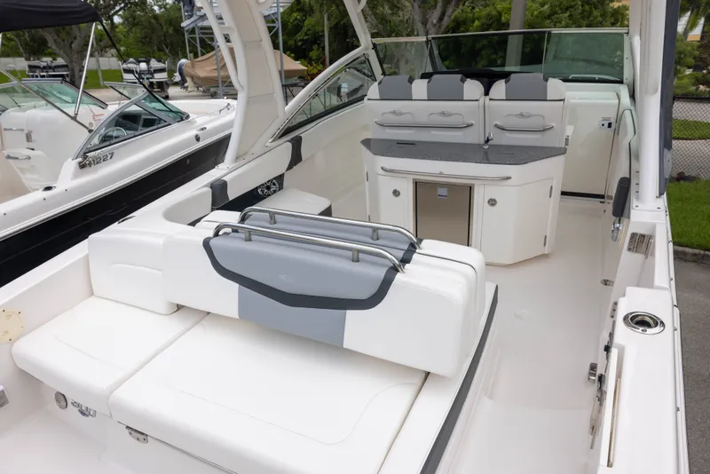 Slide: The Image of The image shows the cockpit of a 2023 Chaparral 300 OSX with white upholstery and gray accents. - 5