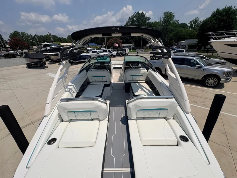 Slide: The Image of 2020 Regal LS4 Surf with a stylish open deck and luxurious white seating, perfect for watersports. - 13