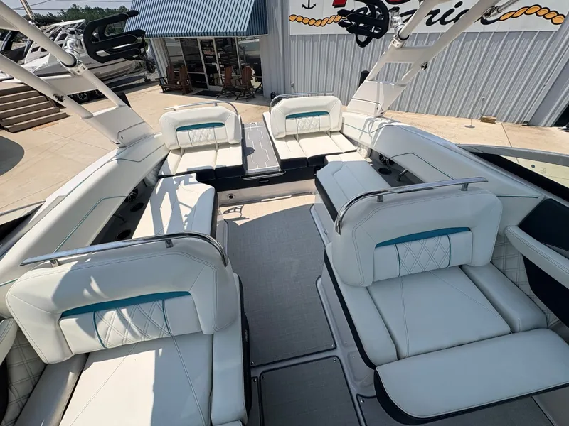 Slide: The Image of The image shows the interior of a 2020 Regal LS4 Surf boat with white upholstery. - 19