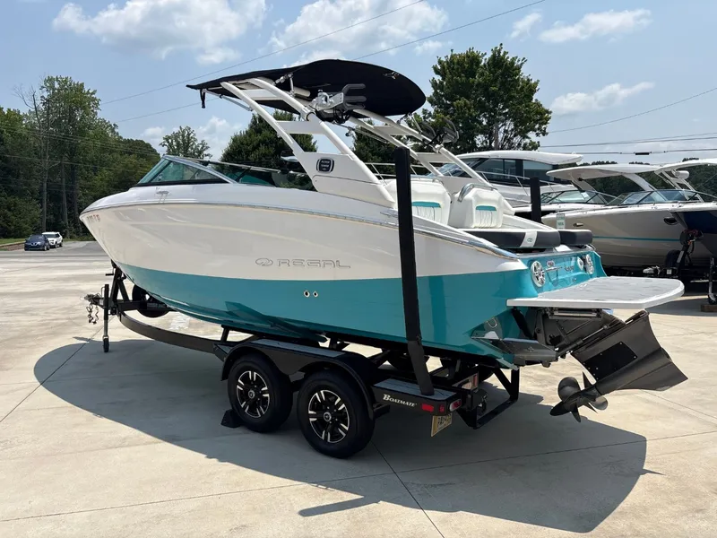 Slide: The Image of 2020 Regal LS4 Surf with turquoise hull, on a trailer, ready for adventure. - 9