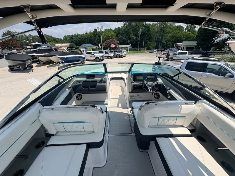 Slide: The Image of Interior view of a 2020 Regal LS4 Surf boat with white seating and a modern dashboard. - 20