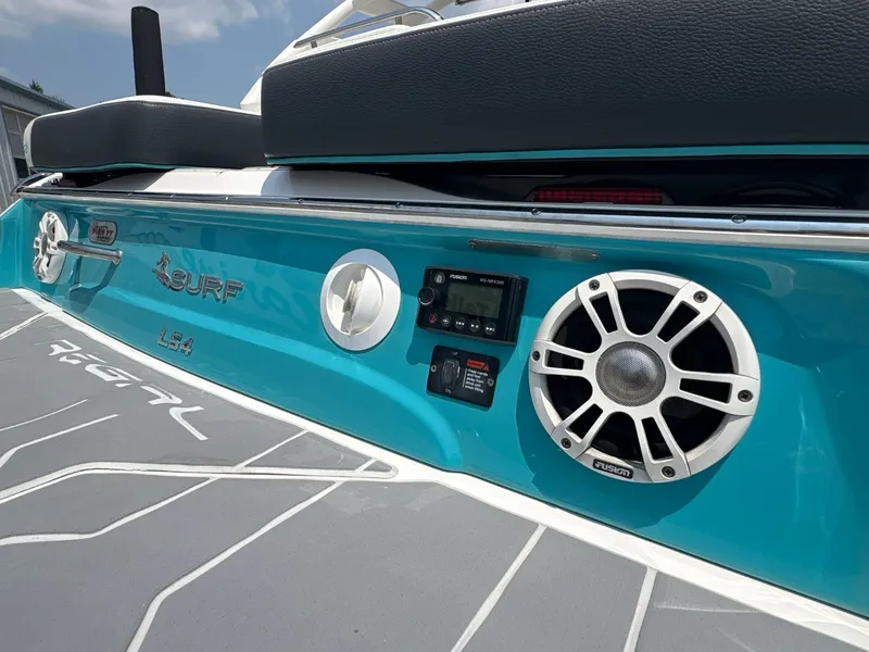 Slide: The Image of The image shows the rear of a 2020 Regal LS4 Surf boat with speakers and controls. - 12