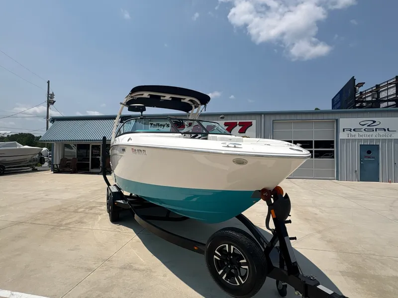 Slide: The Image of 2020 Regal LS4 Surf boat on a trailer in front of a building with Regal logo. - 5