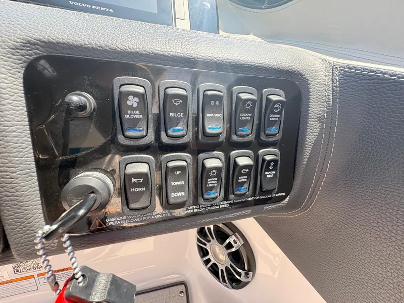 Slide: The Image of Dashboard of a 2020 Regal LS4 Surf boat with various switches and a speaker. - 16