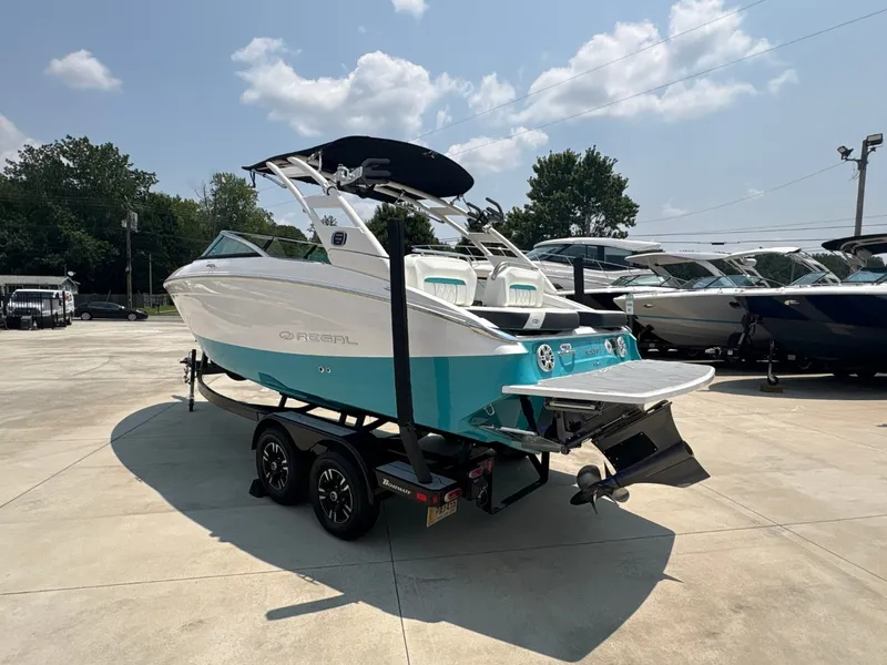 Slide: The Image of A 2020 Regal LS4 Surf boat on a trailer in a concrete lot. - 7