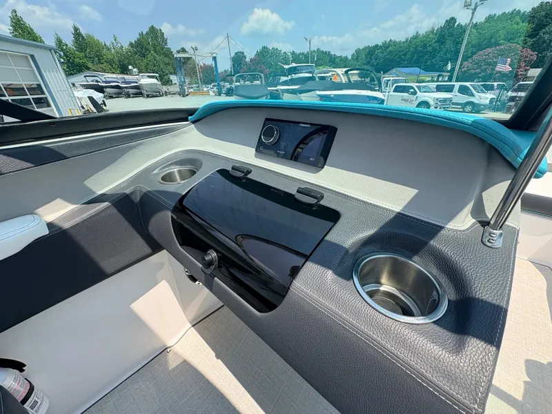 Slide: The Image of The image shows the cockpit of a 2020 Regal LS4 Surf with modern controls and cup holders. - 18
