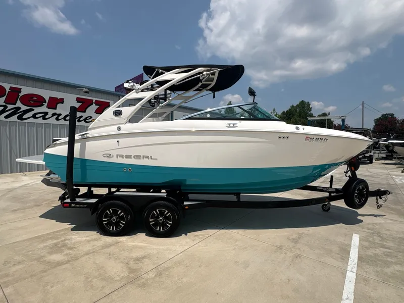 Slide: The Image of 2020 Regal LS4 Surf: Sleek design with blue and white paint, on a trailer outdoors. - 3