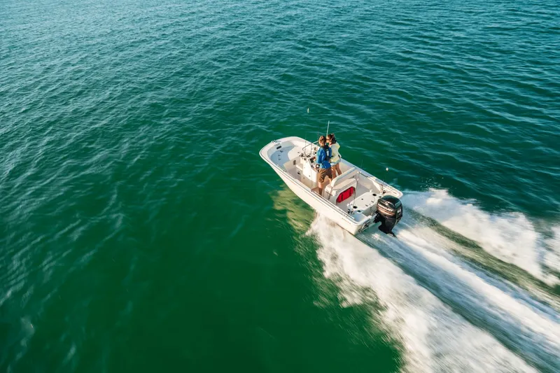 Slide: The Image of A 2027 Boston Whaler 150 Montauk speeds across the open sea. - 14