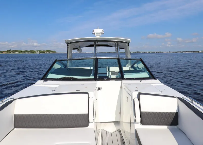 Slide: The Image of 2023 Monterey 385 Super Sport boat on calm water under a clear blue sky. - 33