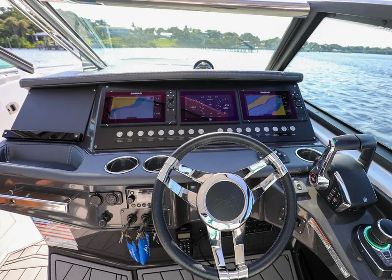 Slide: The Image of 2023 Monterey 385 Super Sport boat dashboard with modern controls and steering wheel. - 22