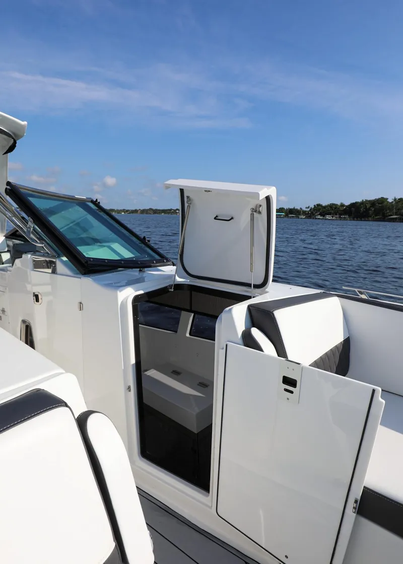 Slide: The Image of 2023 Monterey 385 Super Sport boat interior with open door, on a sunny day by the water. - 34