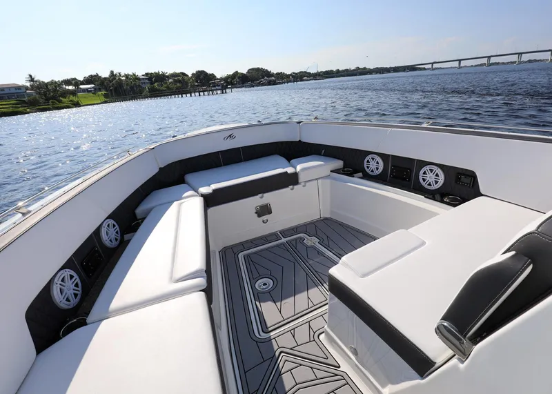 Slide: The Image of 2023 Monterey 385 Super Sport boat interior with luxurious seating and scenic water view. - 27
