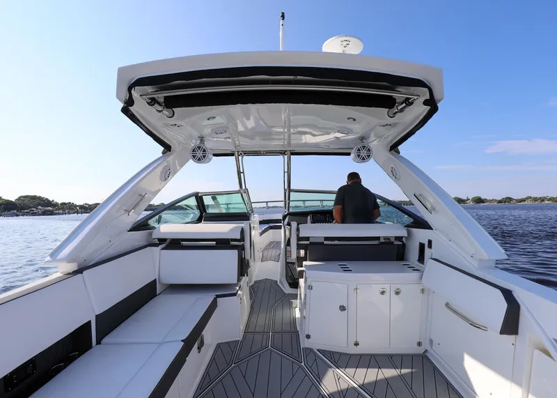 Slide: The Image of 2023 Monterey 385 Super Sport boat interior with seating and helm, on a sunny day. - 13
