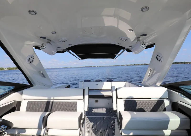 Slide: The Image of 2023 Monterey 385 Super Sport boat interior with luxurious seating and lake view. - 14