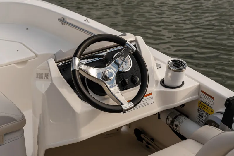 Slide: The Image of The image shows the helm of a 2027 Boston Whaler 130 Super Sport. - 39