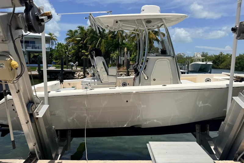 Slide: The Image of 2023 Pathfinder 2400 Open boat docked, surrounded by tropical scenery and clear skies. - 14