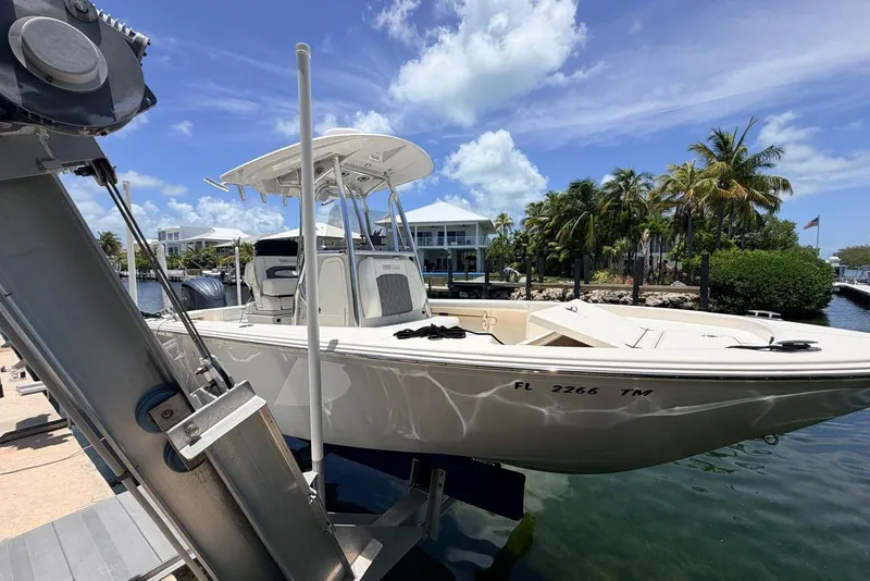 Slide: The Image of 2023 Pathfinder 2400 Open boat docked near palm trees and waterfront homes. - 15