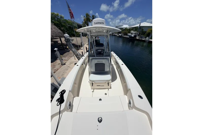 Slide: The Image of 2023 Pathfinder 2400 Open boat docked by a canal under a clear blue sky. - 12