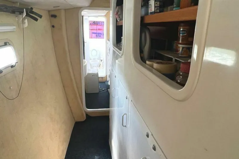 Slide: The Image of Interior of a 1995 Voyage Yachts Mayotte with storage and passage to another area. - 23