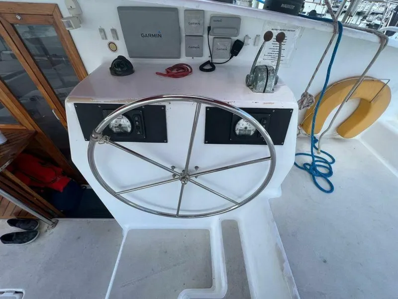 Slide: The Image of Steering wheel of a 1995 Voyage Yachts Mayotte with navigation equipment and a life ring. - 44