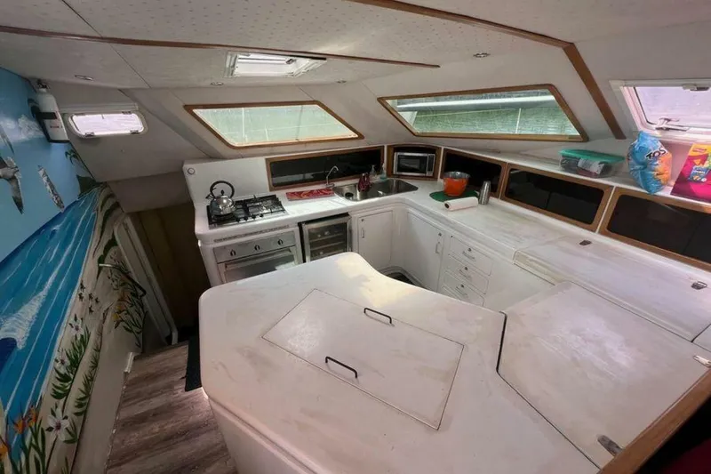 Slide: The Image of Interior of a 1995 Voyage Yachts Mayotte featuring a well-equipped kitchen and colorful wall art. - 40