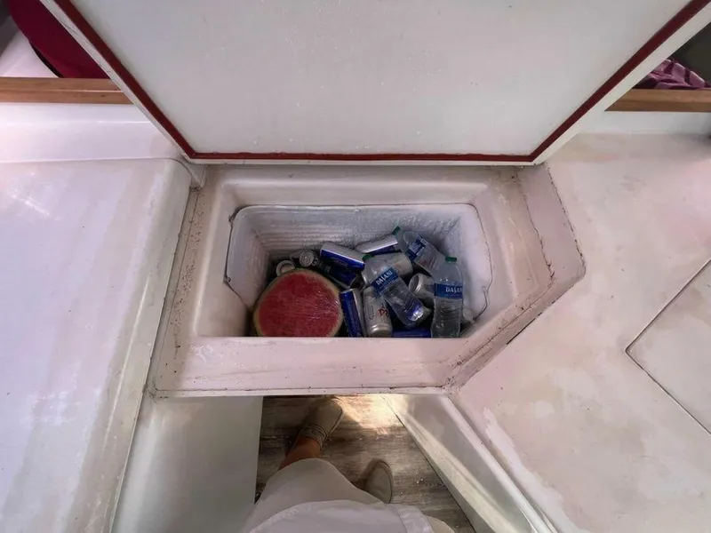 Slide: The Image of An open cooler on a yacht reveals drinks and a half watermelon. - 37