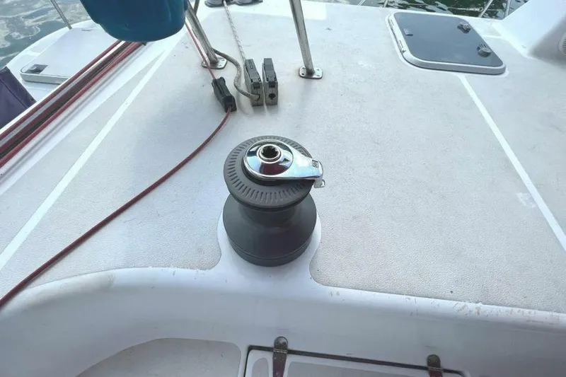 Slide: The Image of The image shows the deck of a sailing yacht with a winch and ropes. - 46