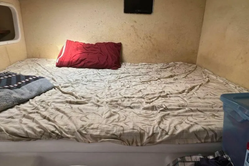 Slide: The Image of Cabin with a double bed and pillows on a yacht. - 21