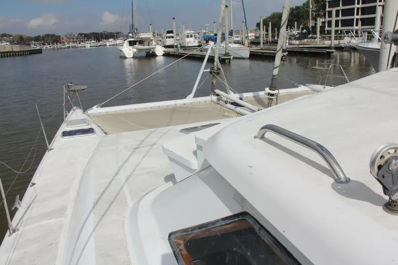 Slide: The Image of A 1995 Voyage Yachts Mayotte is docked in a calm marina with other boats in the background. - 47