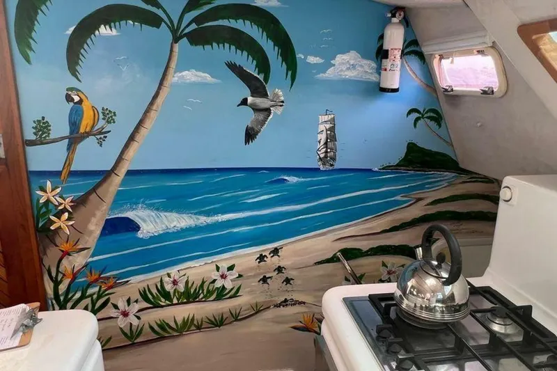 Slide: The Image of The interior wall of a yacht features a tropical mural with a beach, palm trees, and birds. - 31