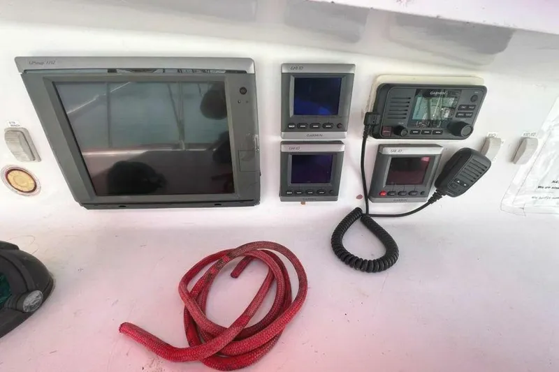 Slide: The Image of The image shows a yacht's helm with multiple screens and a radio. - 42