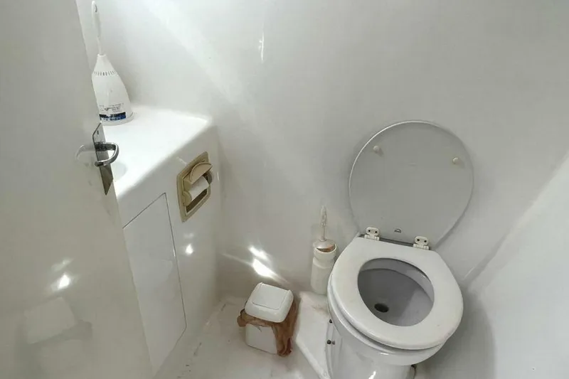 Slide: The Image of Interior view of a boat toilet with a white toilet and sink. - 25