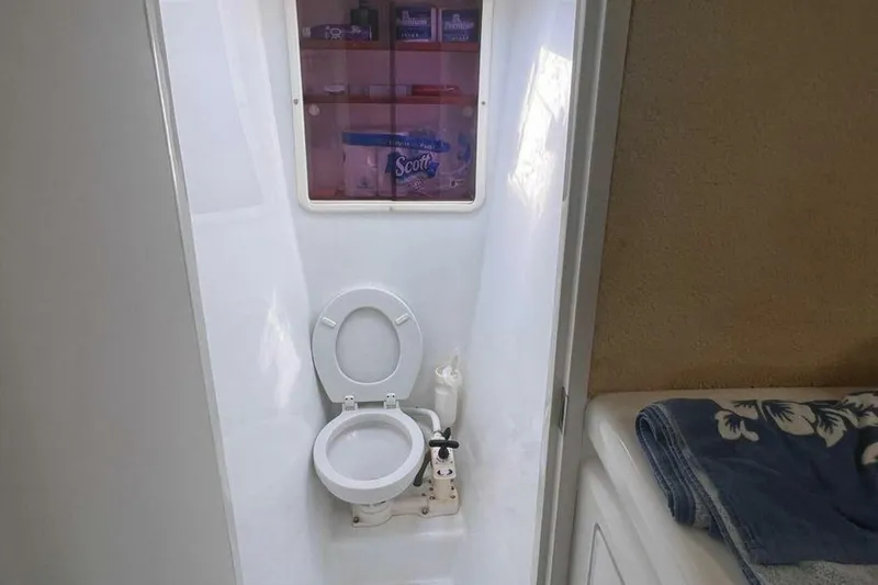 Slide: The Image of Interior of a yacht with a toilet and towels. - 22
