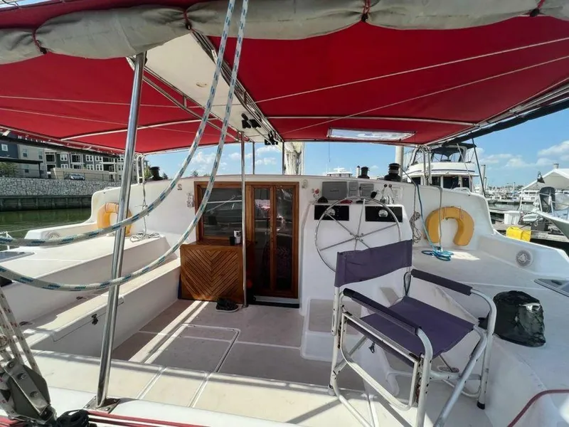 Slide: The Image of The image shows the cockpit of a 1995 Voyage Yachts Mayotte with a red sunshade and steering wheel. - 7