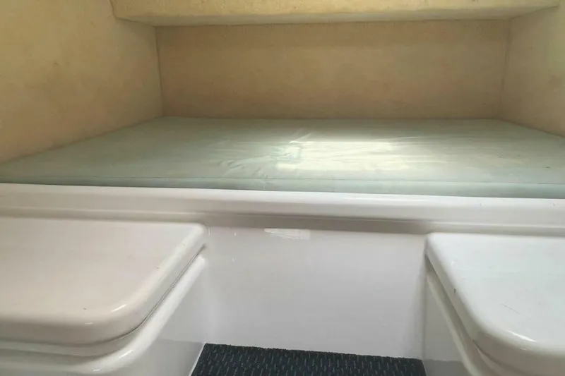 Slide: The Image of Interior of a 1995 Voyage Yachts Mayotte with a cushioned sleeping area and white walls. - 24