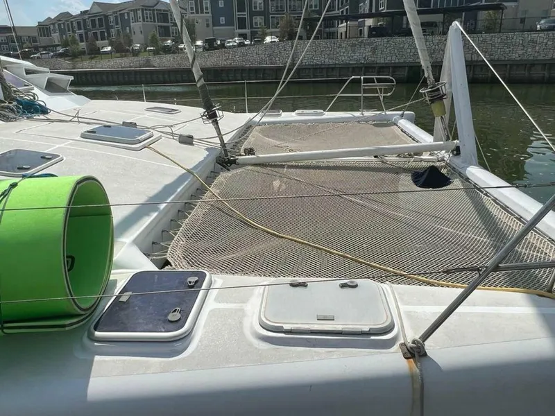 Slide: The Image of Deck view of a 1995 Voyage Yachts Mayotte with nets and hatches, docked in a harbor. - 2