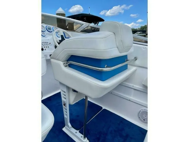 Slide: The Image of The image shows a boat's helm with a white seat and blue accents. - 7