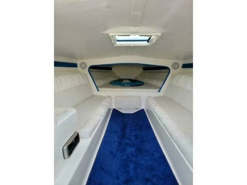 Slide: The Image of Interior of the 2002 Profile 33 V with blue carpeting and white upholstery. - 5