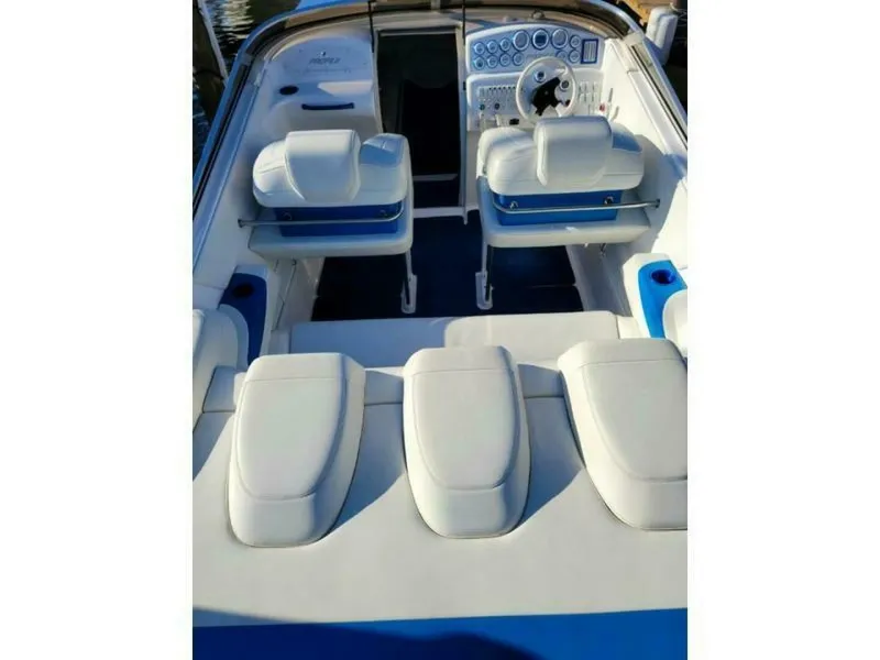 Slide: The Image of The image shows the cockpit of a 2002 Profile 33 V boat with white seats and blue accents. - 9